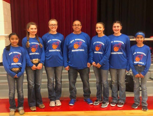 Adult and students with basketball themed shirts