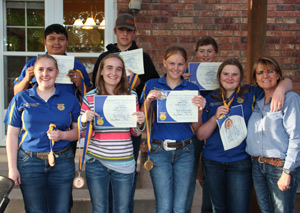 Group of students holding up certificates